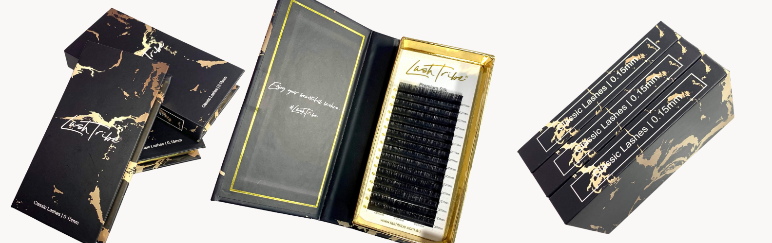 A set of black and gold eyelash extensions in a box.