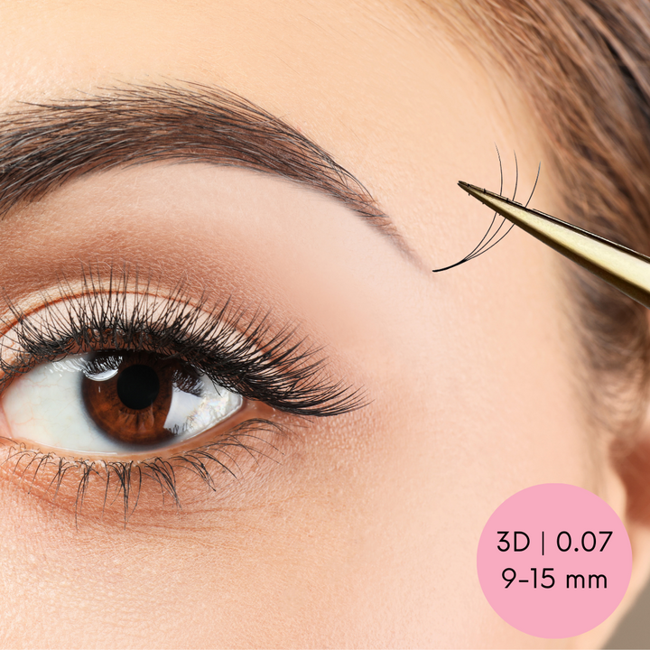 A woman's eyelashes are being trimmed with a pair of Lash Tribe Loose Premade Volume Fans | Long Stem | Ultra Black.