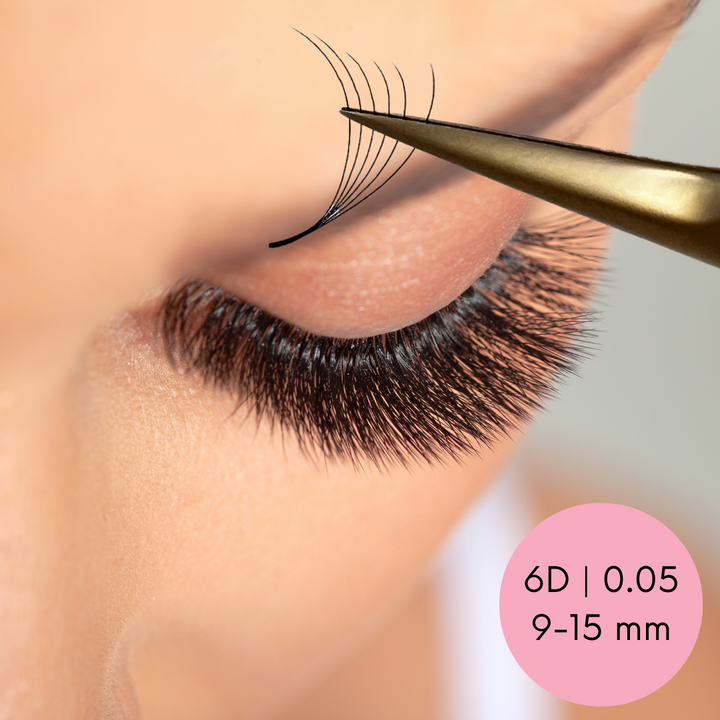 A woman's eyelashes are being applied with a pair of Lash Tribe Loose Premade Volume Fans | Long Stem | Ultra Black.