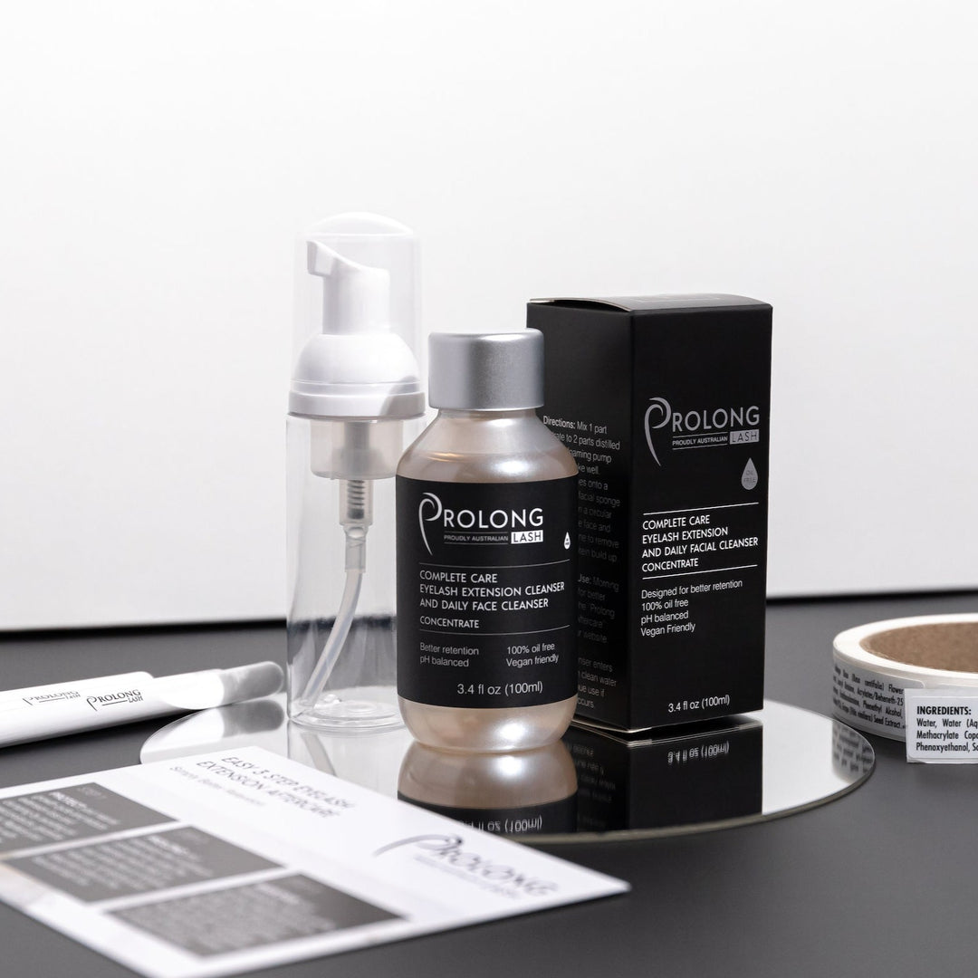 Prolong Lash EYELASH EXTENSION CLEANSER CONCENTRATE 100ml on a dark bench with bottle