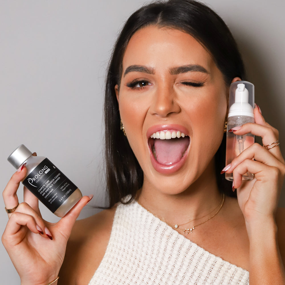 Prolong Lash EYELASH EXTENSION CLEANSER CONCENTRATE 100ml held by a model