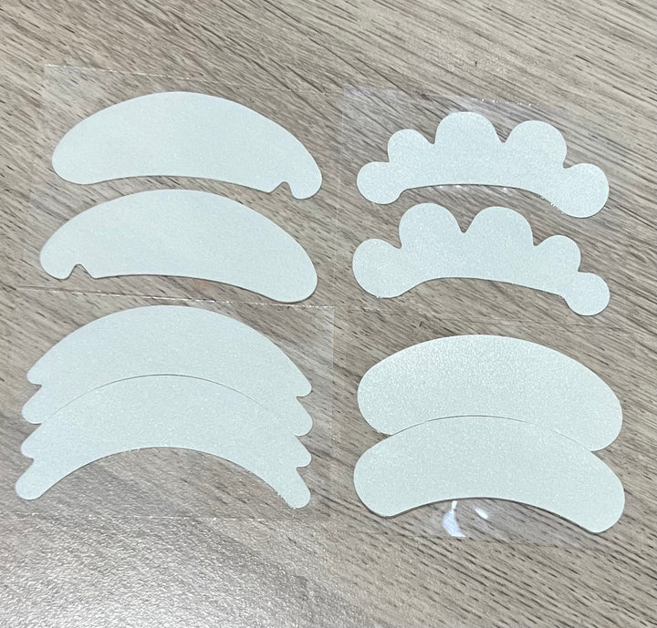 A set of Microfoam Eye Pads stickers on a wooden table.