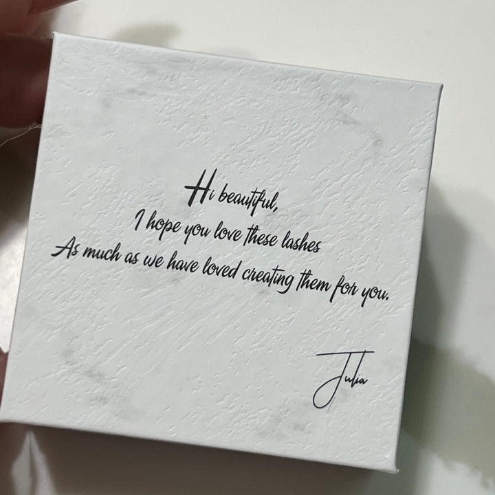 A white box of Loose Premade Volume Fans | Long Stem | Ultra Black by Lash Tribe that says i'm beautiful.