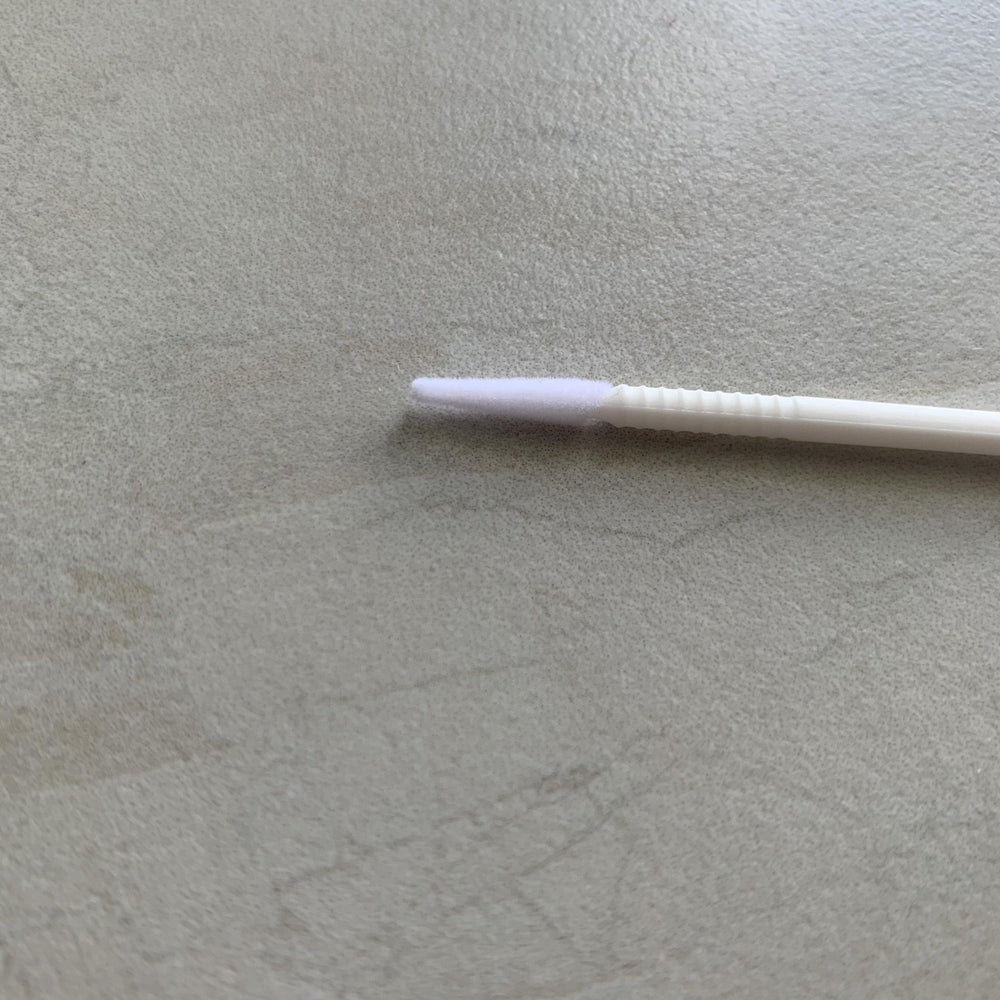 A Long-tipped Micro brush from Lash Tribe is sitting on a table.