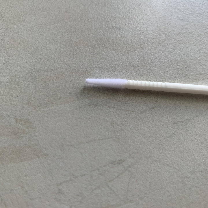 A Long-tipped Micro brush from Lash Tribe is sitting on a table.