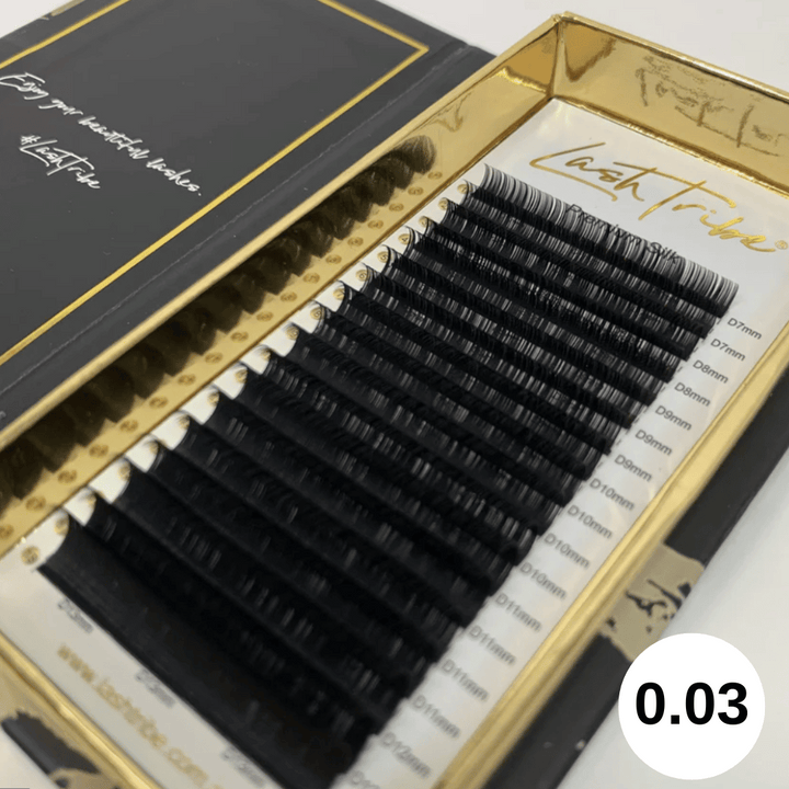 An open box of Lash Tribe's 0.03 Russian Volume Lashes - Mixed Tray | Premium Silk | Ultra Black displayed in increasing lengths.