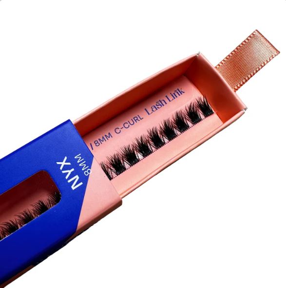 The pink and blue box labeled "8mm C-Curl FULL VOLUME | NYX | LASH LINK LASH EXTENSIONS RIBBON" contains Volume Lash Extensions, ideal for crafting your Signature Lash Look.