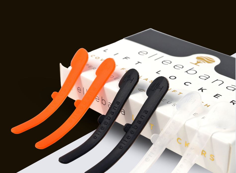 A set of four LASH TRIBE Lash Lift Lockers in a box, featuring orange and black plastic clips for an ELLEEBANA Lash Lifting Experience.