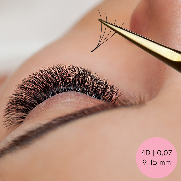 A woman's eyelashes are being trimmed with a pair of Lash Tribe's Loose Premade Volume Fans | Long Stem | Ultra Black scissors.