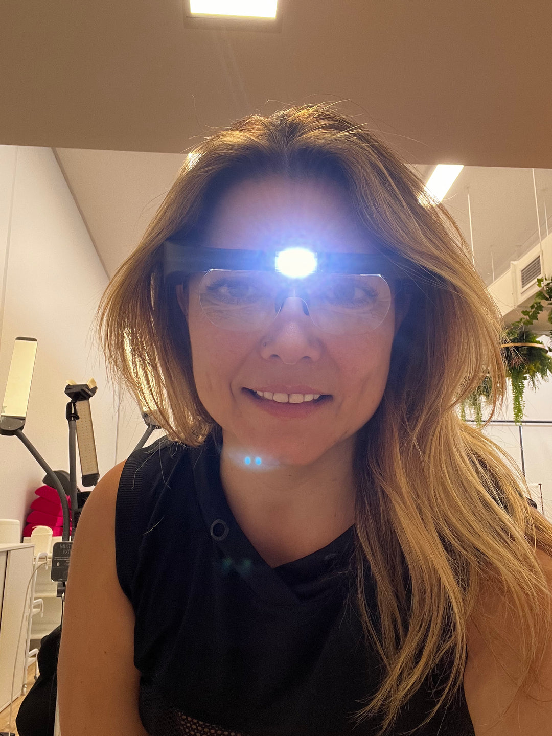 a woman wearing Lash Tribe Magnifying Glasses with Led Light in a gym.