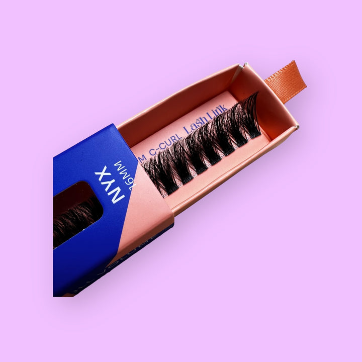 A box of false eyelashes labeled "FULL VOLUME | NYX | LASH LINK LASH EXTENSIONS RIBBON" sits elegantly on a purple background, promising full volume and a stunning lash extension style.