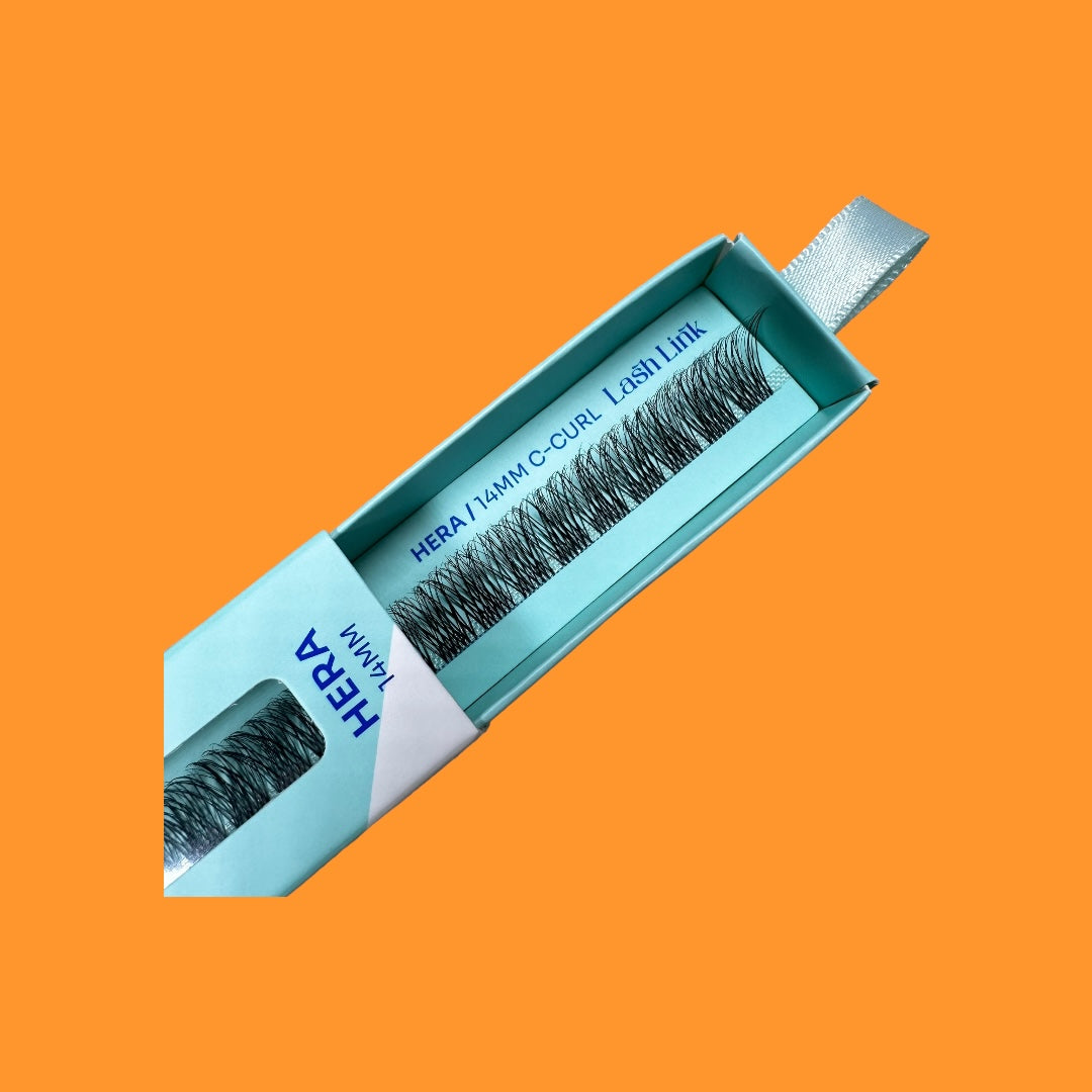 The Lash Link DIY Eyelash Extension Kit by Lash Link, featuring "14mm C-Curl Lash 1 Line," includes visible black lashes, making it perfect for those looking to apply their own eyelash extensions at home. Set against an orange background, it's ideal for your Eyelash Extension Home Studio.