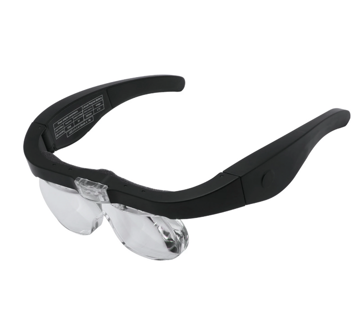 A pair of Magnifying Glasses with Led Light from Lash Tribe with a black frame and clear lenses.