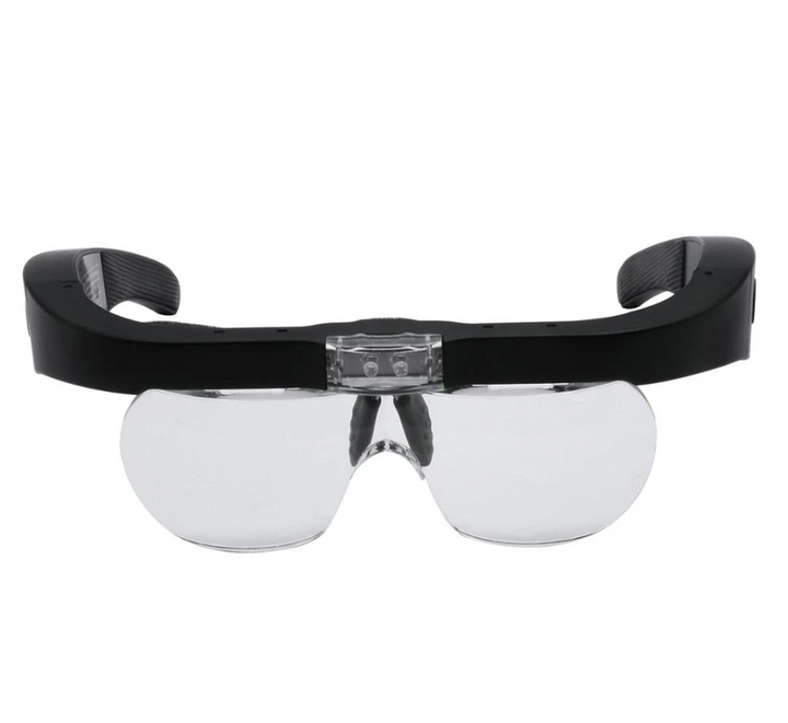 A pair of Magnifying Glasses with Led Light by Lash Tribe with a black frame and clear lenses.