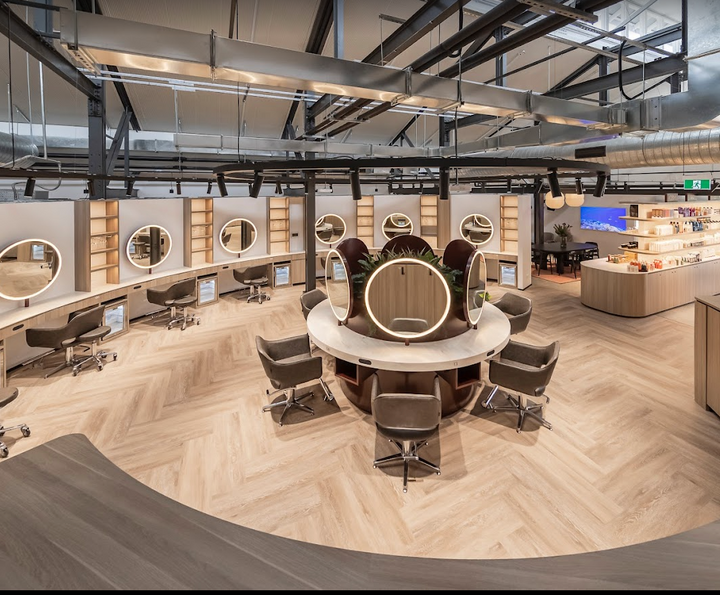 The interior of a Lash Tribe hair salon with a circular table and chairs.