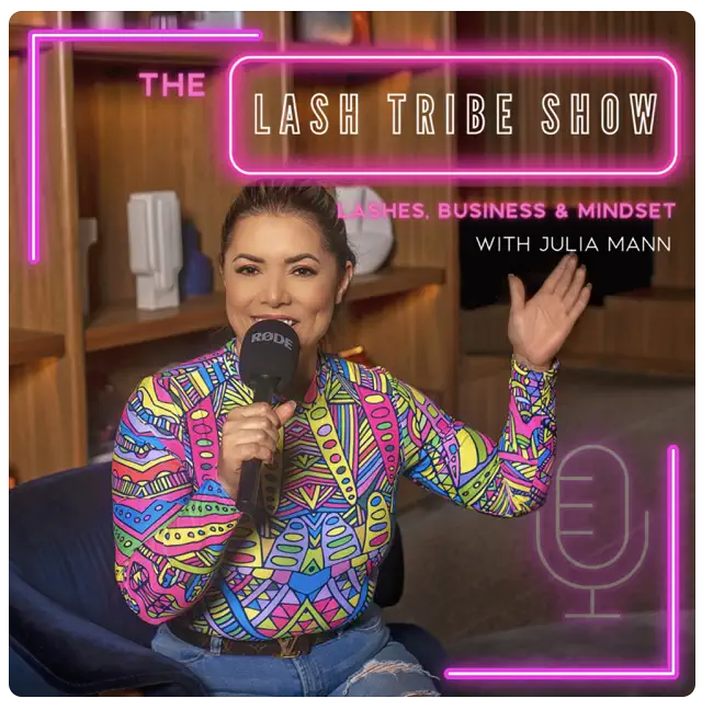 Julia Mann from the Lash Tribe show holding a microphone wearing a bright top