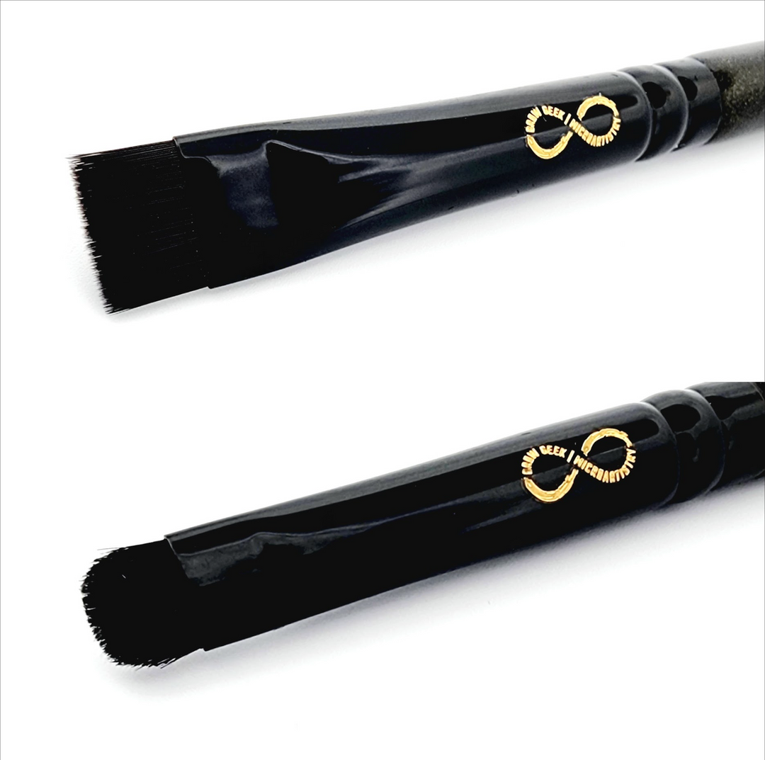 a black Infinity Buff & Blend Brush with a gold handle and a black handle.