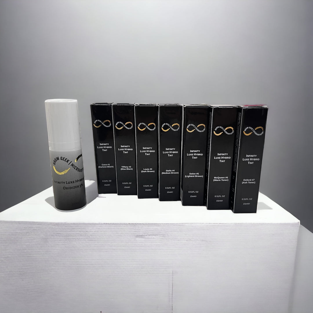 A group of Lash Tribe Infinity Luxe Hybrid Brow Tint KIT | Brow Tint and Lash Tint Cream Color | Bronze Kit products on a white table.