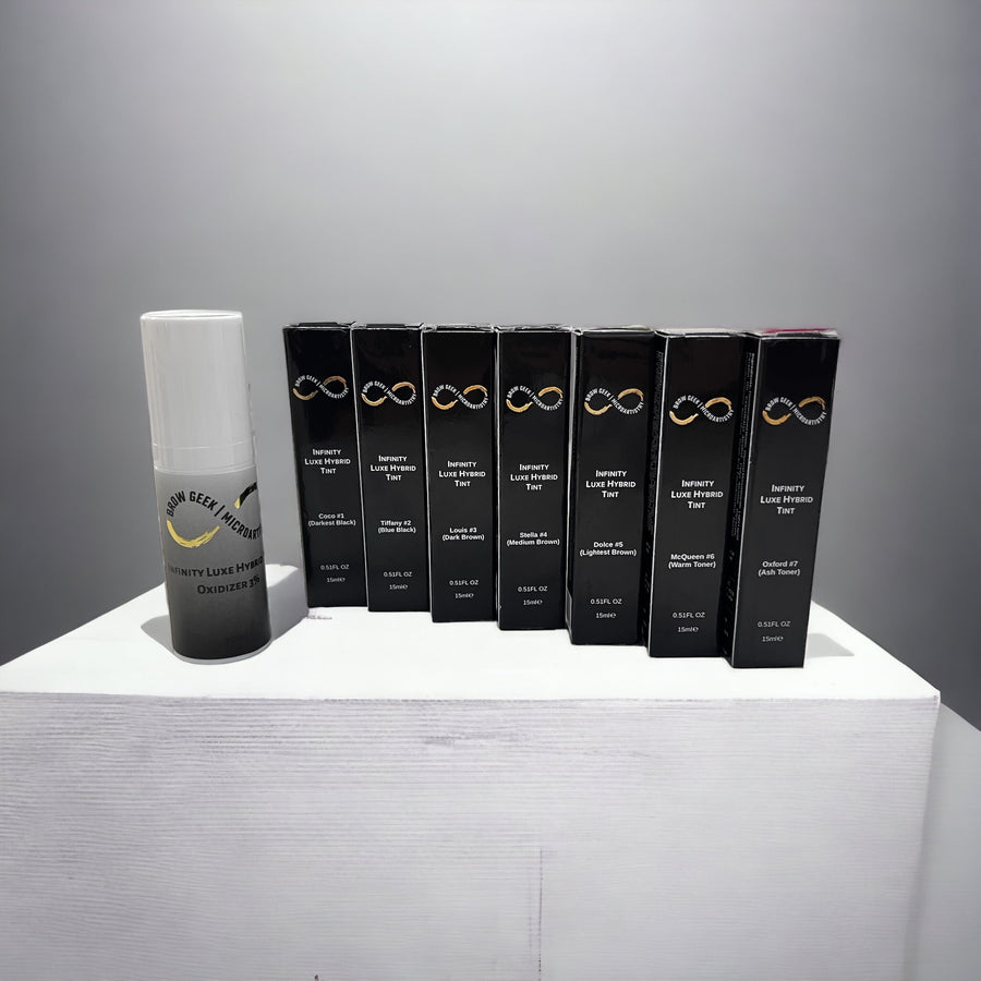 A group of Lash Tribe Infinity Luxe Hybrid Brow Tint KIT | Brow Tint and Lash Tint Cream Color | Bronze Kit products on a white table.
