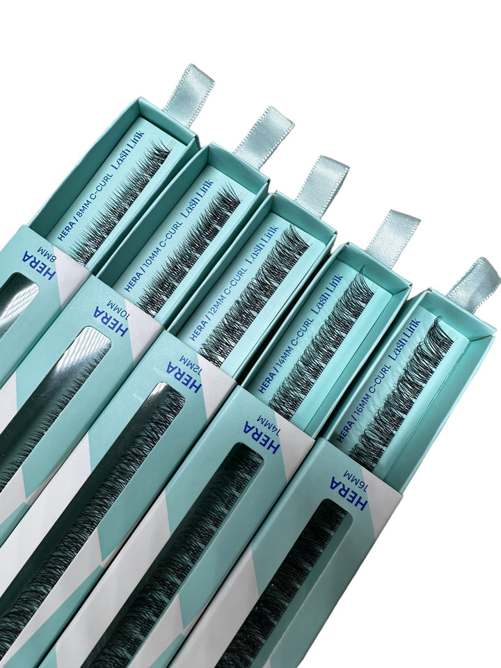 Five teal boxes of Lash Link's Light Volume Lash Extensions, featuring "HERA" and "LASH LINK," promise an effortless enhancement of natural beauty.