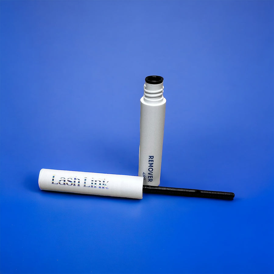 The white tube labeled "Lash Link Remover | Extension Remover Oil" with its black wand is set against a blue background, promising a DIY lash refresh dream.