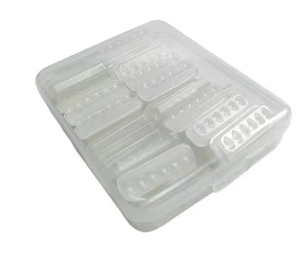 A transparent plastic pill organizer with multiple compartments arranged in rows, similar to the structure of the Lash Tribe Self Adhesive Mini Eyelash Glue Trays.