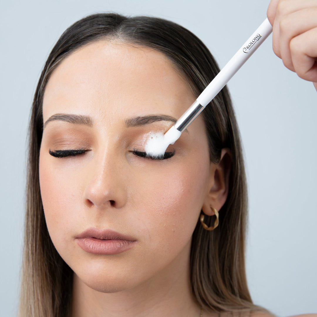 A woman is using a PROLONG LASH | EYELASH EXTENSION FOAMING CLEANSER PUMP 100ml by Lash Tribe to apply eyeliner.