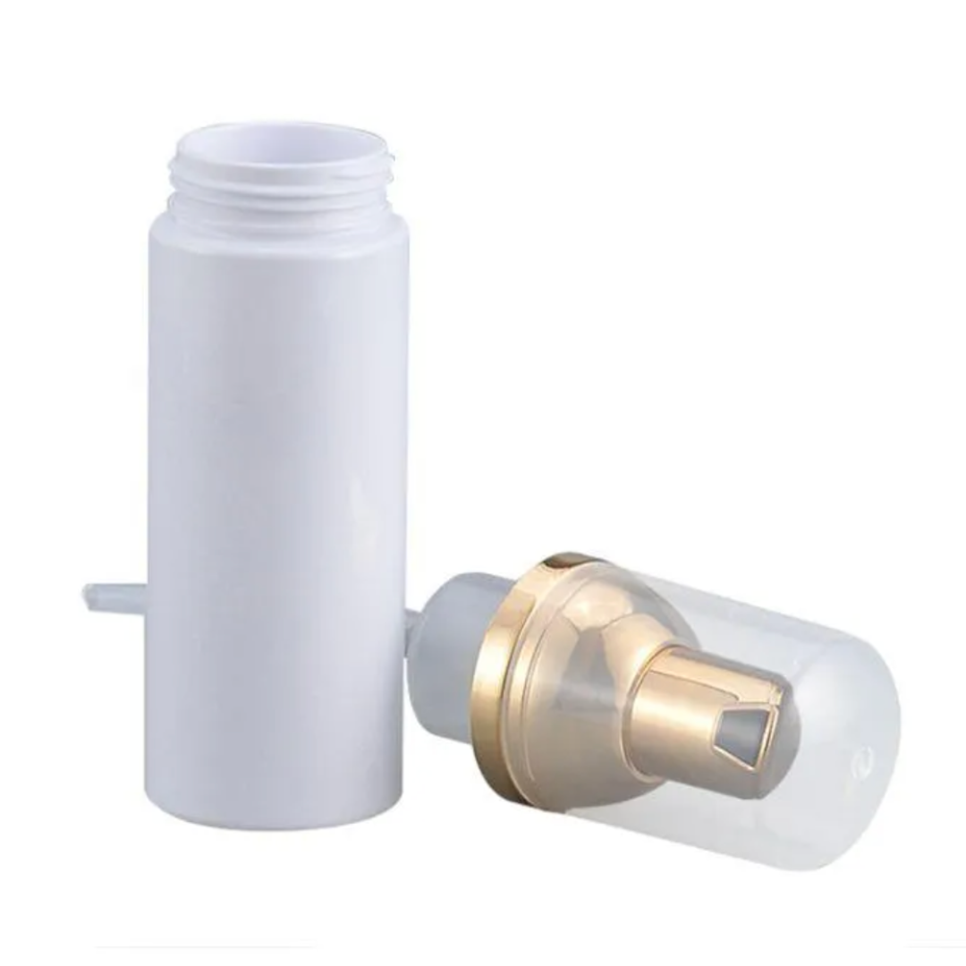 An empty Lash Tribe 50ml Foaming Bottle with a gold lid.