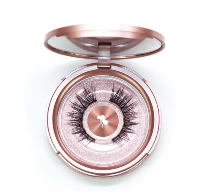 a pink compact with Silk Magnetic Lashes by Lash Tribe in it.