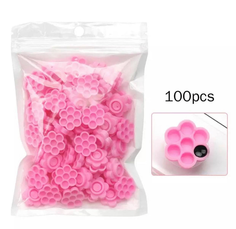 100pcs pink plastic Lash Glue Holder Flower Cups in a bag from Lash Tribe.