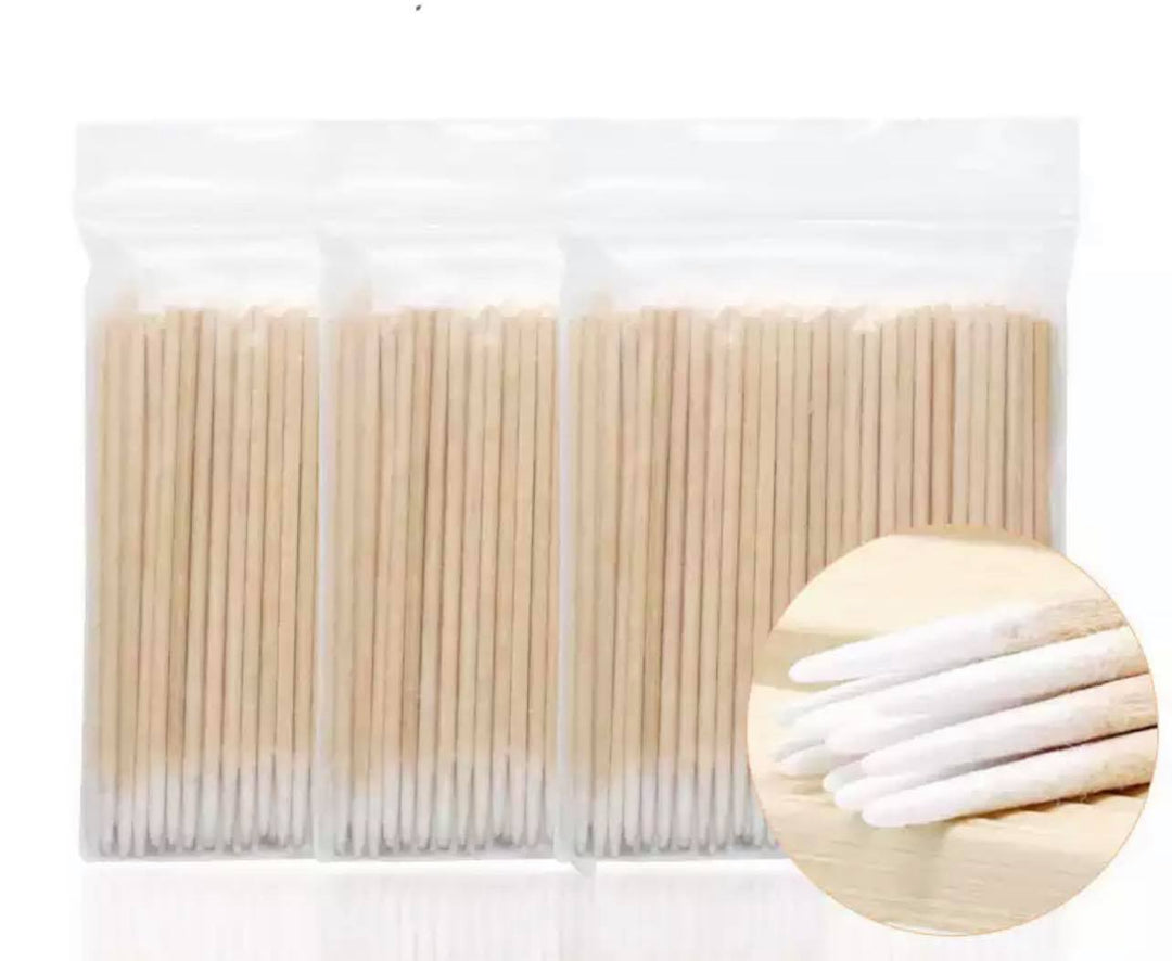 A pack of "Wooden cotton swab sticks" by "Lash Tribe" in a plastic bag.