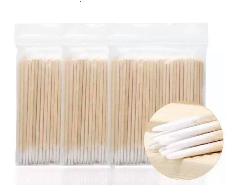 A pack of "Wooden cotton swab sticks" by "Lash Tribe" in a plastic bag.