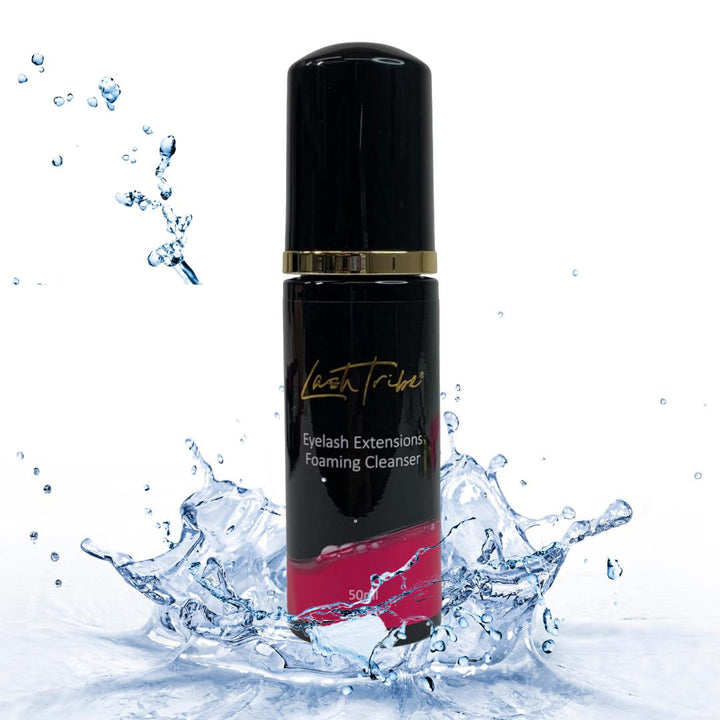 an image of a bottle of Lash Tribe Eyelash Extensions Foaming Cleanser with a pink bottle and a splash of water.