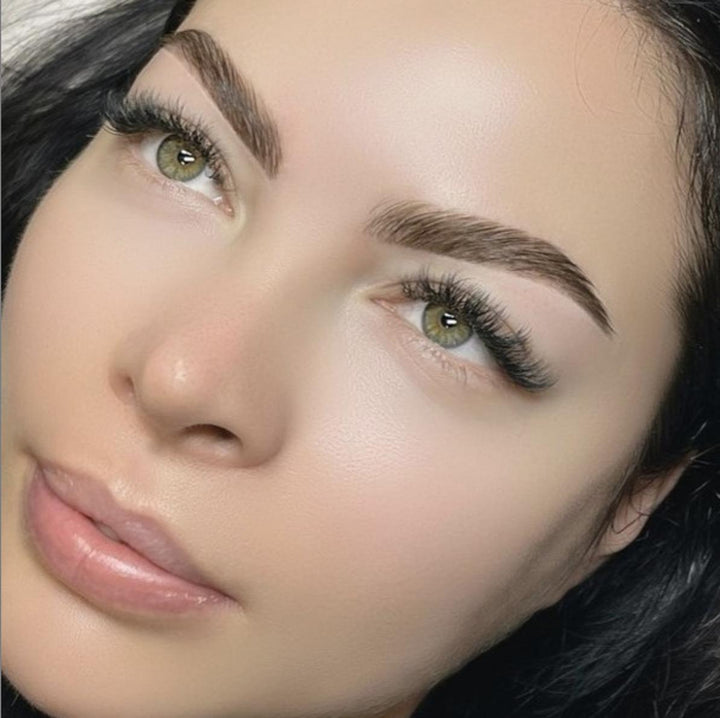 A close up of a woman with green eyes using the Elleeplex Profusion Colour System Kit by Elleebana.