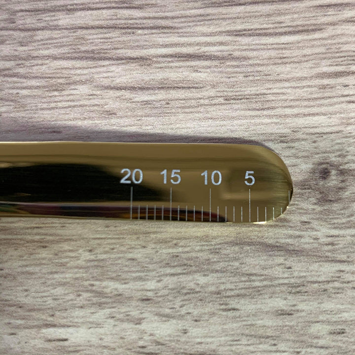 A Julia's Fave Volume Tweezers | Russian Volume Tweezer by Lash Tribe on a wooden table.