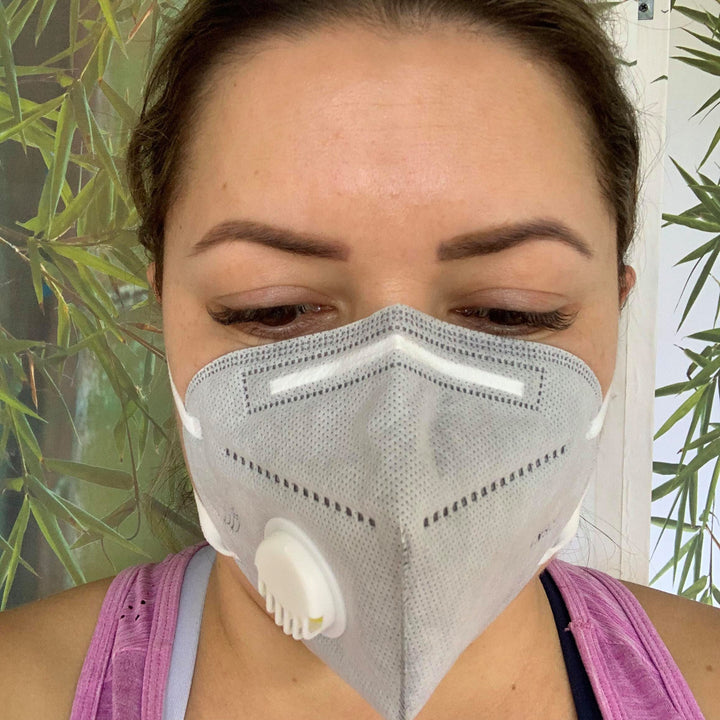 A woman wearing a Lash Tribe KN95 Medical Grade Mask with Valve.