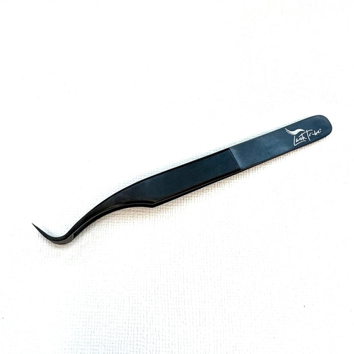 a small Nano Fibre Tip | Volume Tweezers- Black Beauty 1 on a white surface from Lash Tribe.