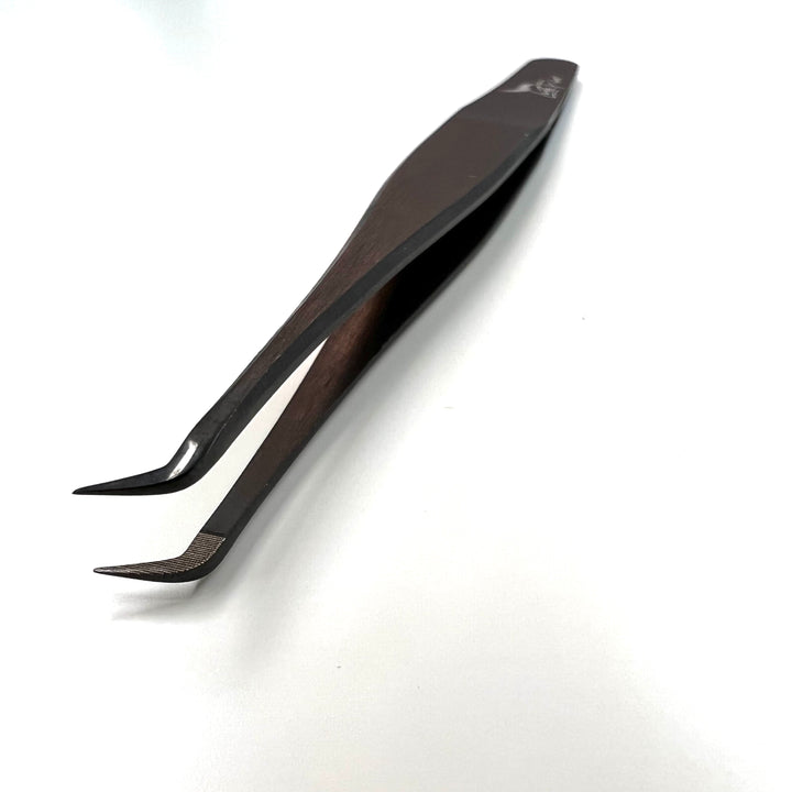 A pair of black Nano Fibre Tip | Volume Tweezers - Black Beauty 2 by Lash Tribe on a white surface.