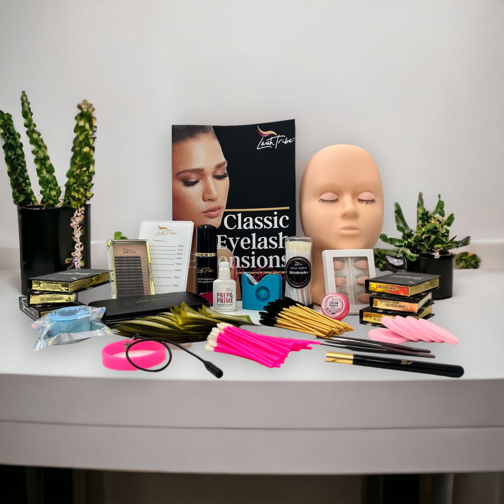 a table with Lash Tribe's Classic Beginners Fundamentals | Online Eyelash Extension Course and a mannequin.