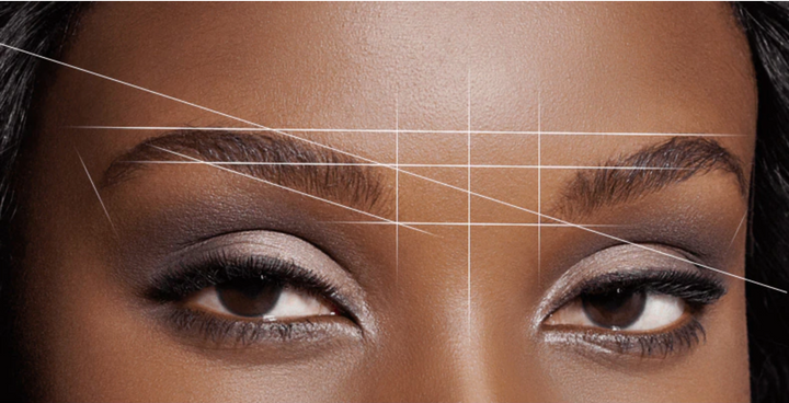 an image of a woman's eyebrows with Lash Tribe Brow Mapping String lines drawn on them.