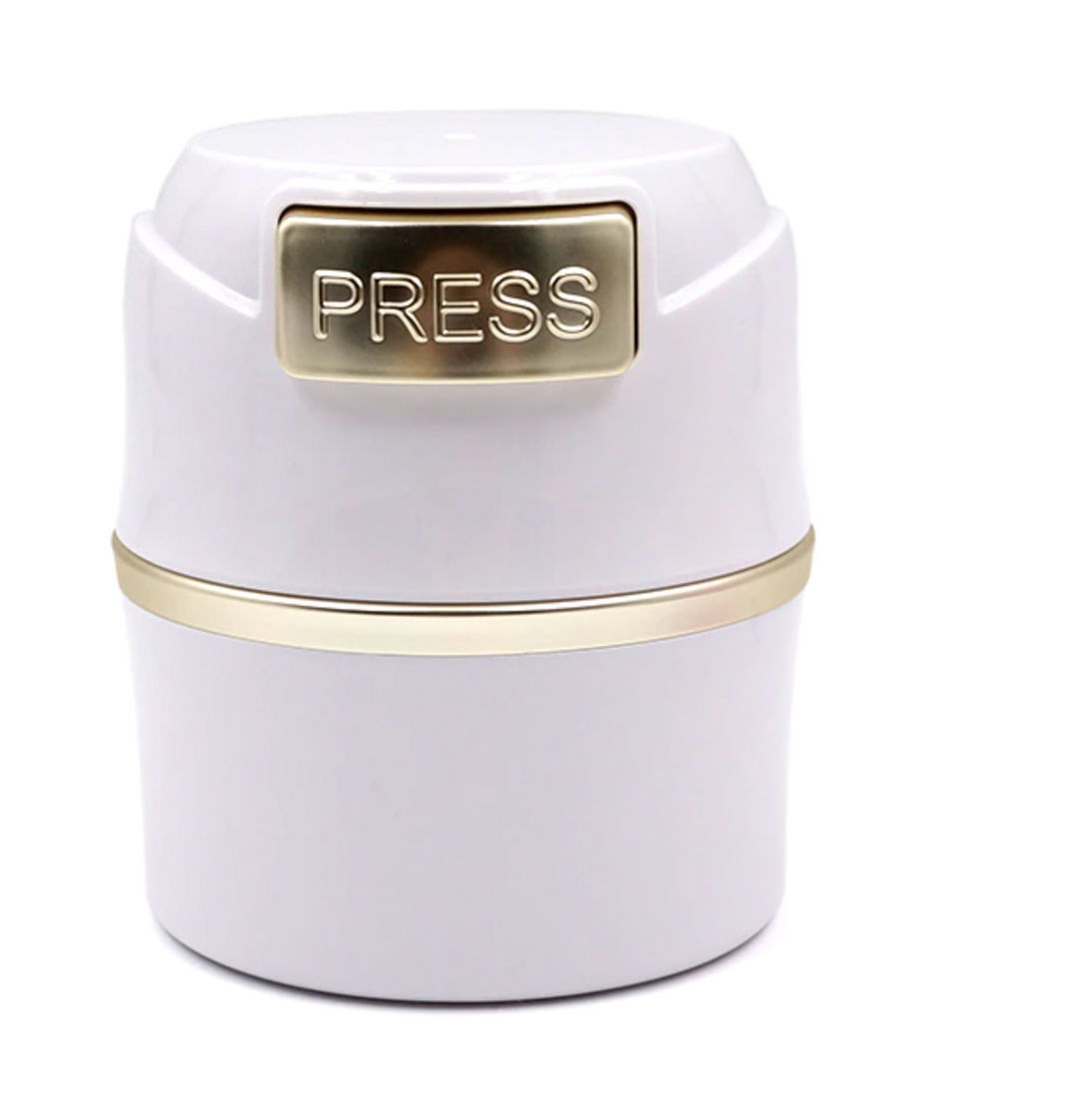 a white Lash Tribe container with the word "press" on it.
