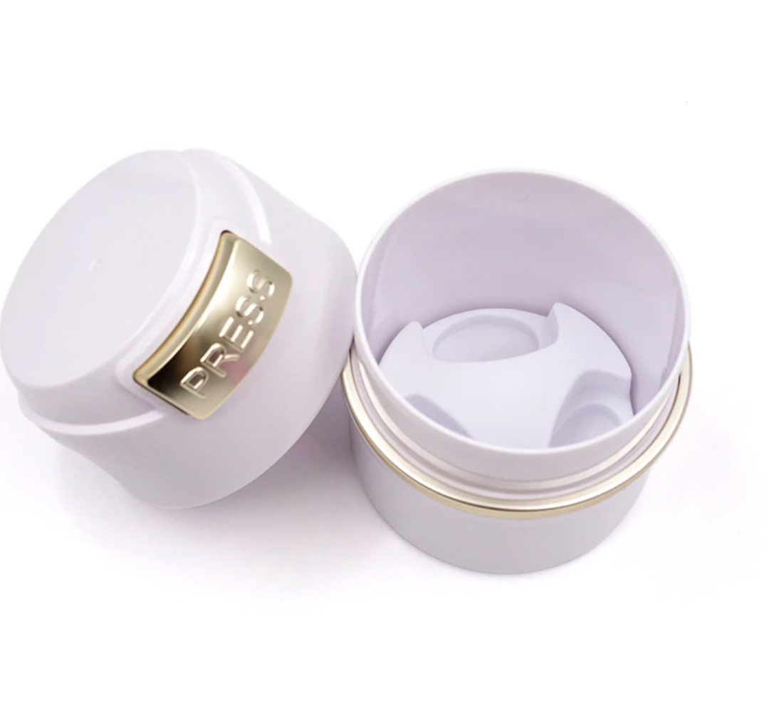 a Lash Tribe white plastic container with a gold lid, specifically designed for storing lash glue or lash extension adhesive.