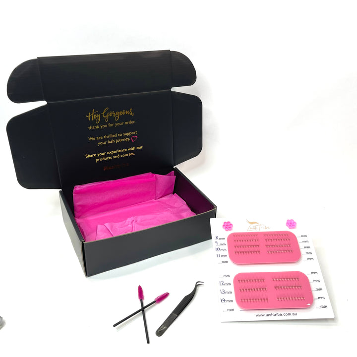 a pink box with a pair of Mega Lash Tile | Left & Right Handed scissors and a pair of tweezers by Lash Tribe.
