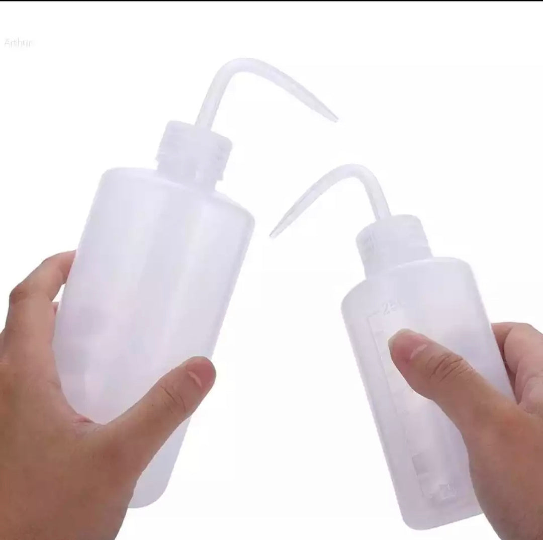 Two hands holding two Lash Tribe Plastic Squeeze Water Bottles.