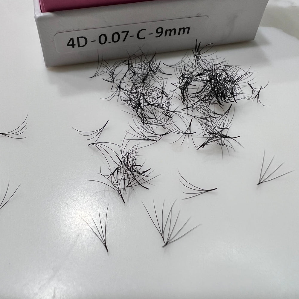 A box of Lash Tribe Loose Premade Volume Fans | Long Stem | Ultra Black eyelashes on a table.