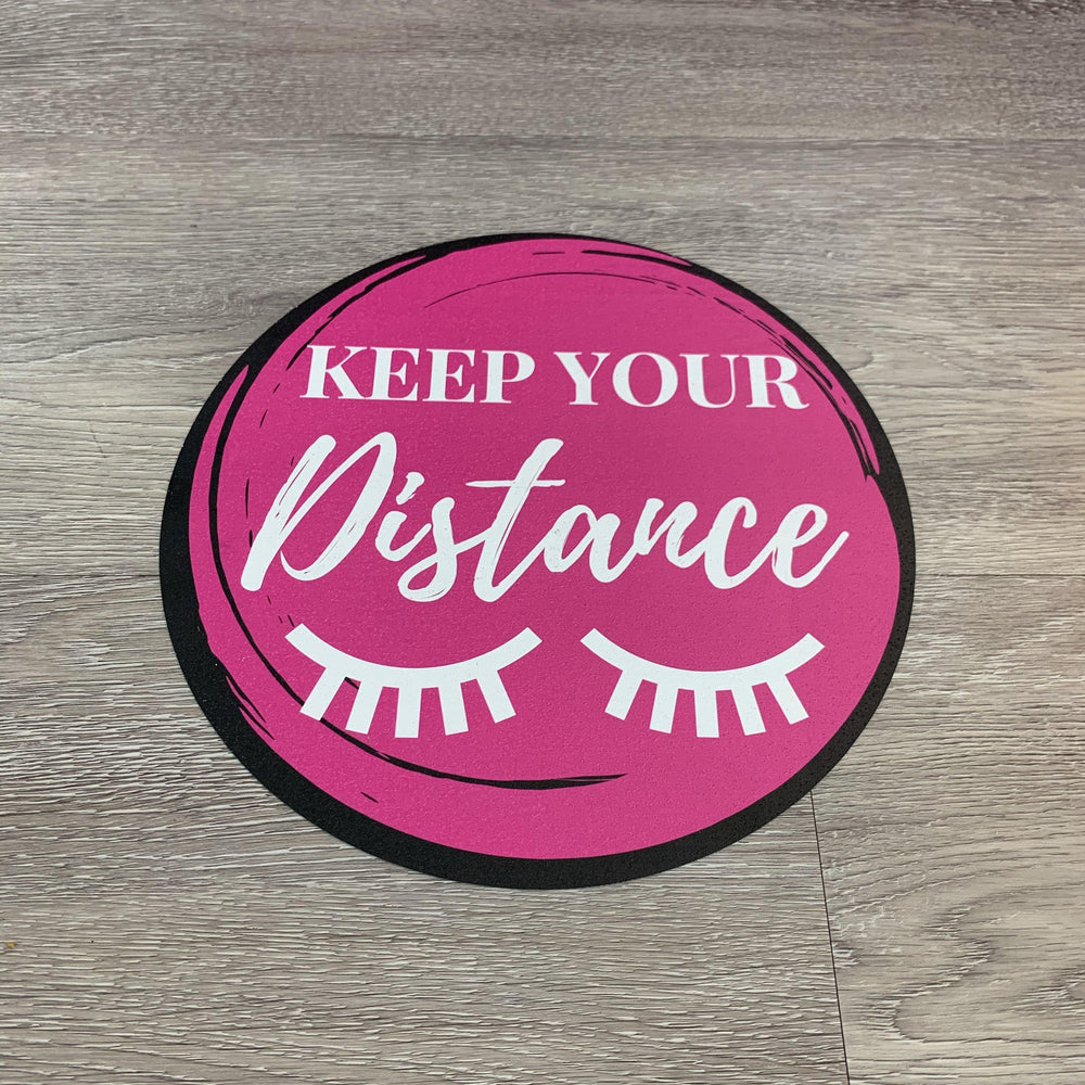 a pink circle with the words Lash Tribe Social Distancing Floor Sticker on it.
