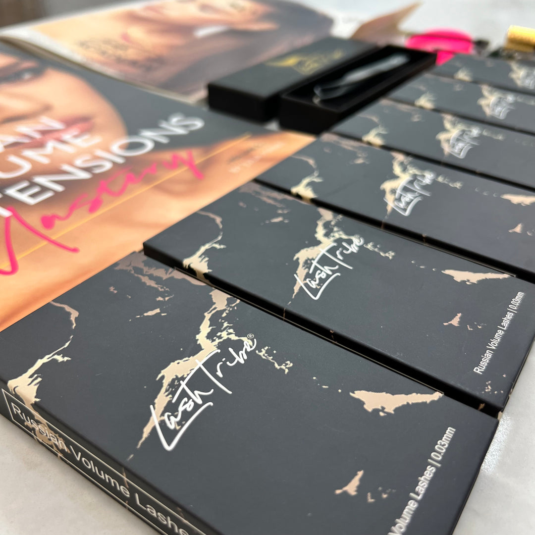 Close-up of Lash Tribe branded Volume Eyelash Extension Starter Kit displayed alongside a mascara box on a white surface.