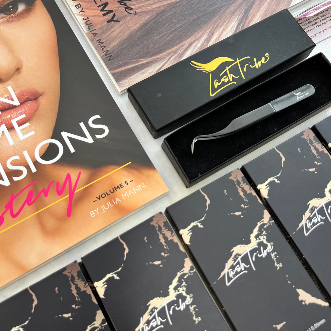 Assorted cosmetic products including the Lash Tribe Volume Eyelash Extension Starter Kit and application tools displayed on a table, featuring branded packaging.