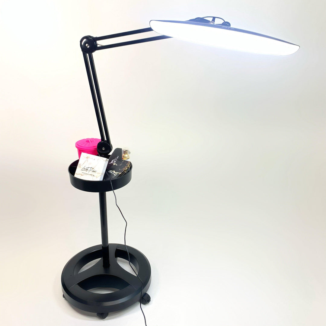 a Lash Light with Storage Tray | Lash Salon Light by Lash Tribe, with a lamp on top of it.