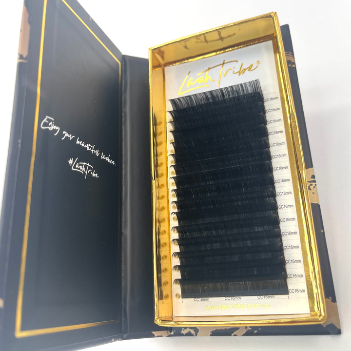 A box of Lash Tribe 0.03 Volume Lashes with various curl thicknesses labeled on the packaging.